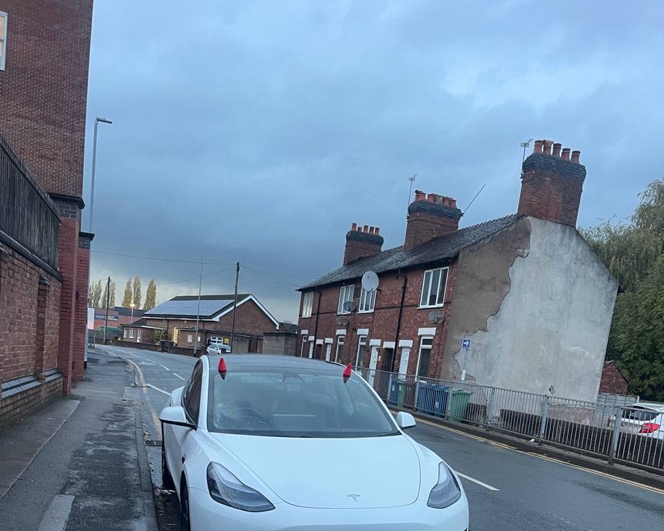 Tesla Model 3 parked with devil horns